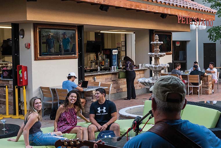 People listen to music at an outdoor patio