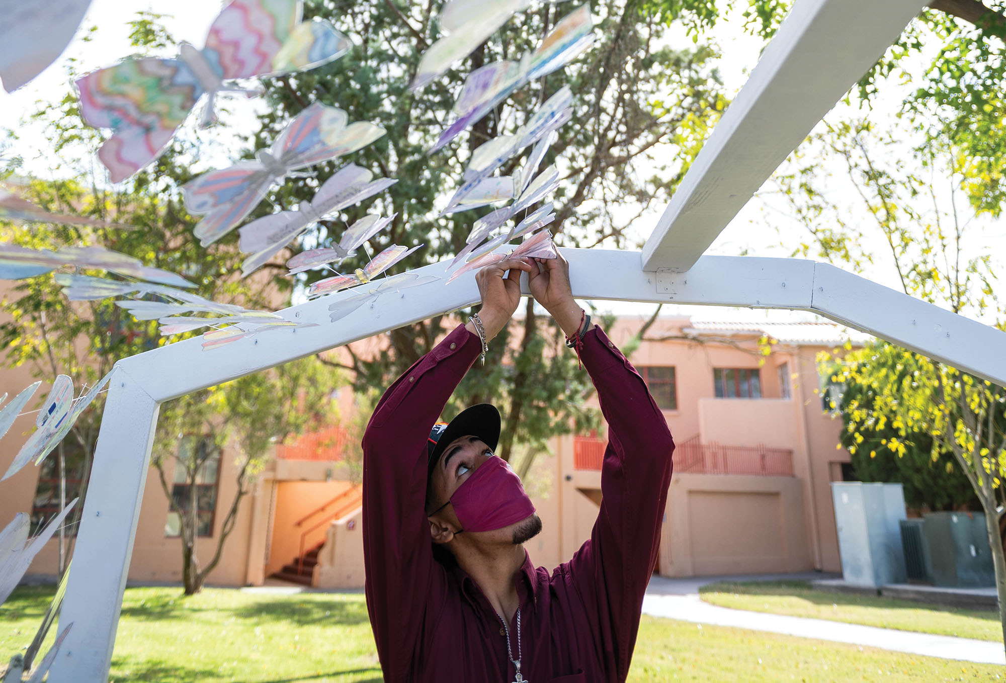 Student helps set up art installation